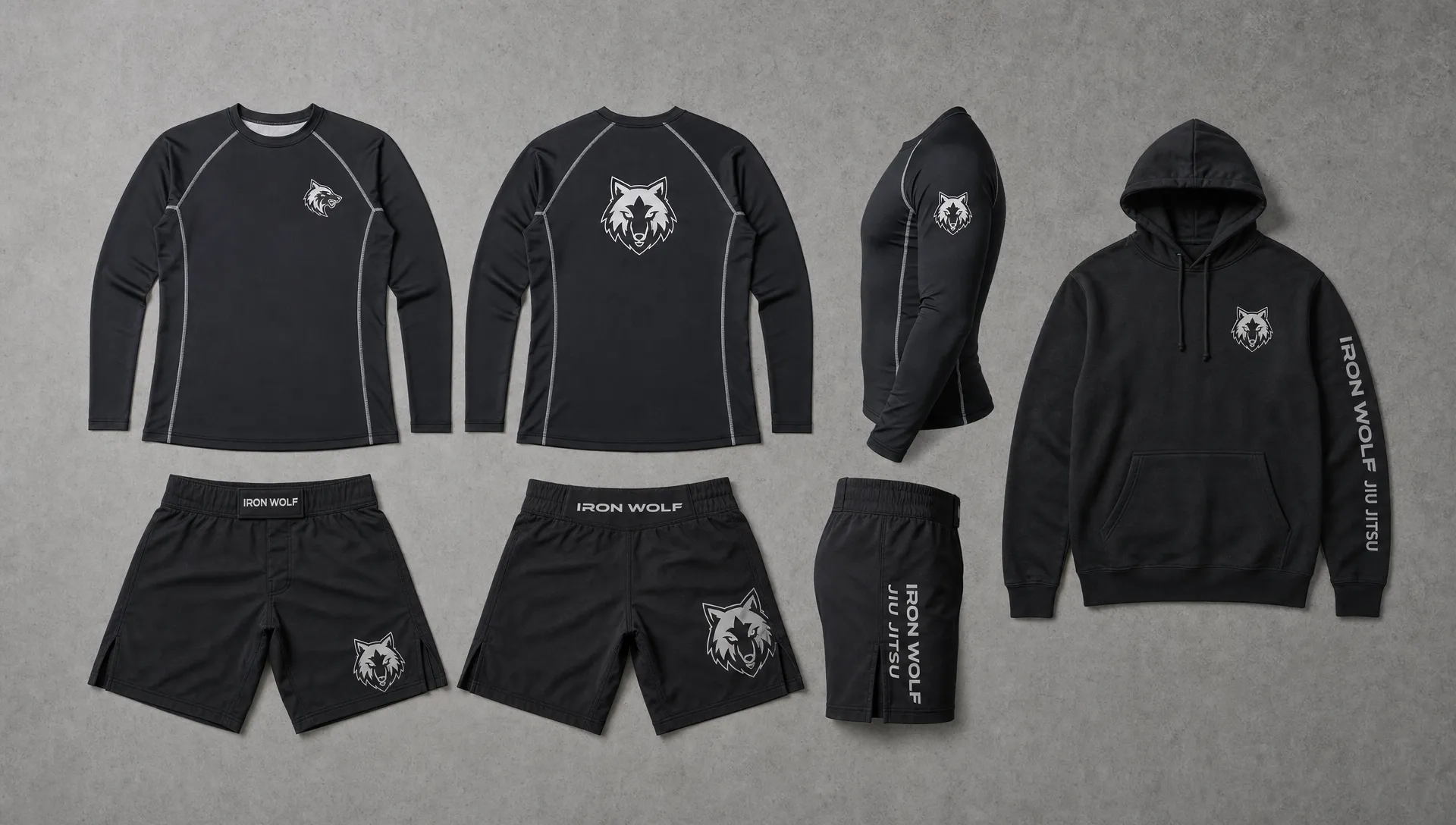 A flat lay of a rash guard, fight shorts, compression top, and hoodie shows different logo placements for athletic wear branding.